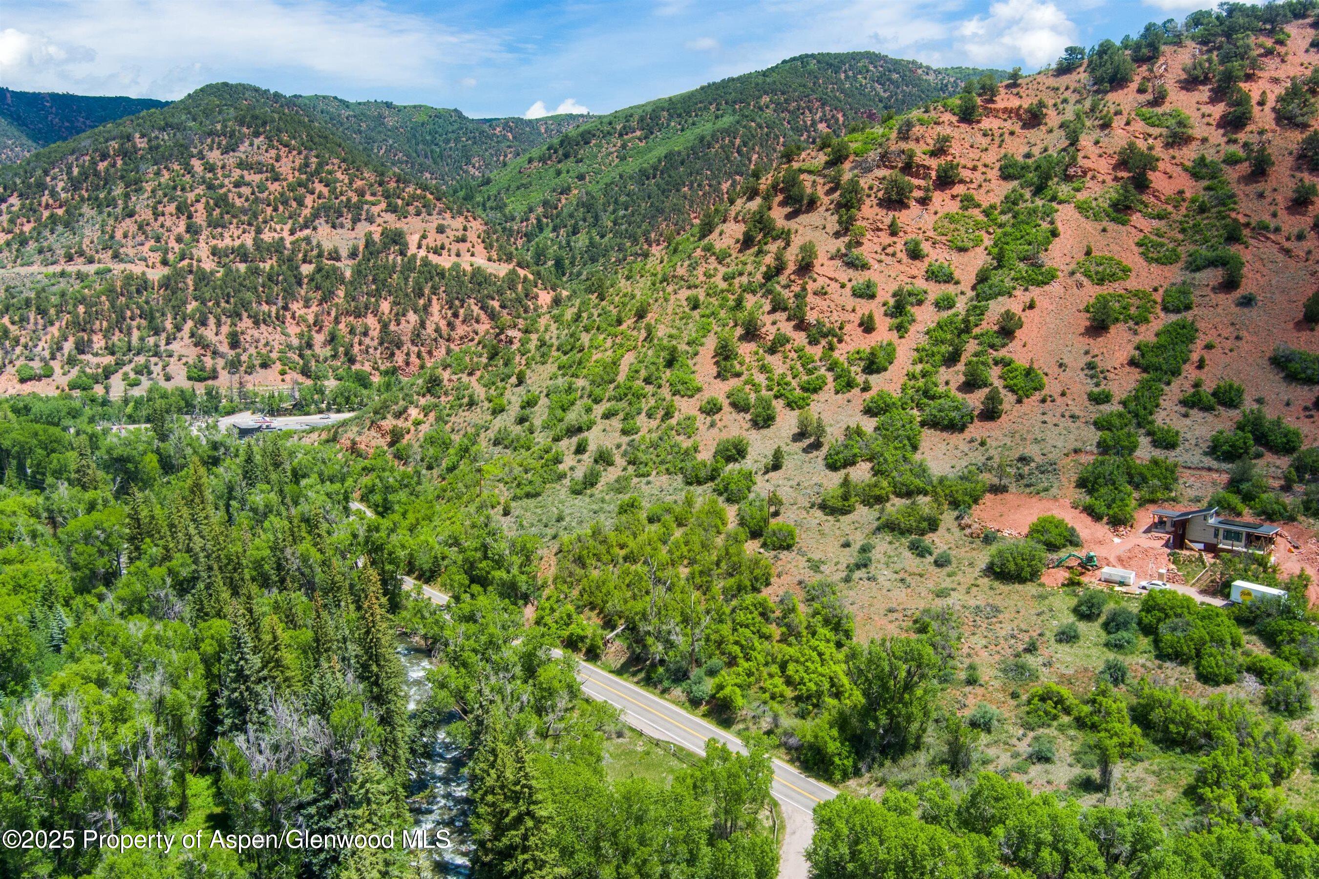 354 Snowmass Creek Road Snowmass, CO 81654 - Photo 15 of 53 a view of a city with lush green forest