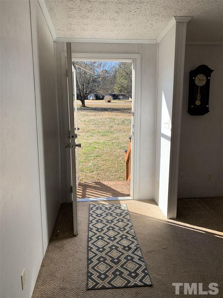 43 Williams Road Spring Hope, NC 27882 - Photo 4 of 30 hallway with wooden floor and a rug