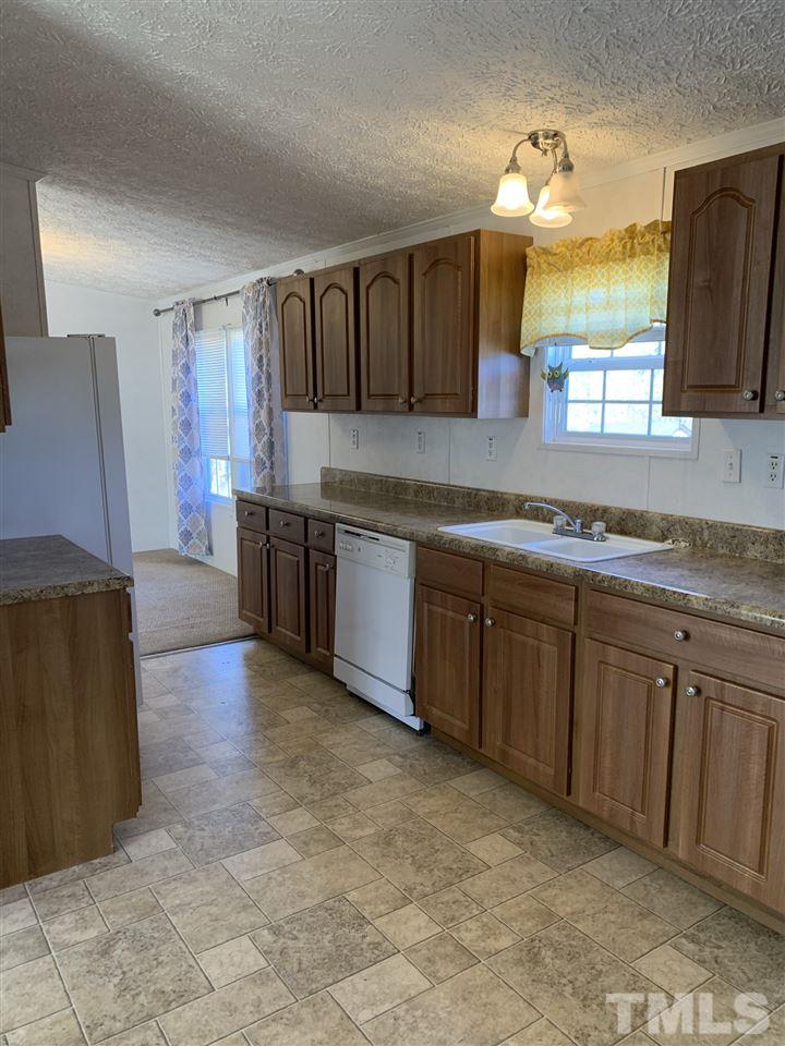 43 Williams Road Spring Hope, NC 27882 - Photo 5 of 30 a large kitchen with stainless steel appliances granite countertop a sink and cabinets