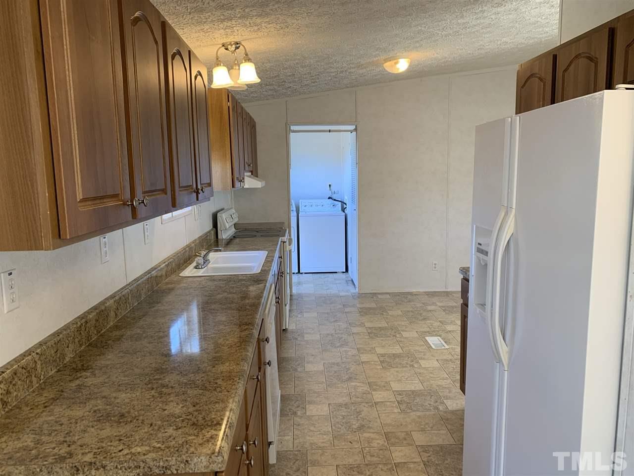 43 Williams Road Spring Hope, NC 27882 - Photo 7 of 30 a bathroom with a granite countertop sink a large mirror and a shower