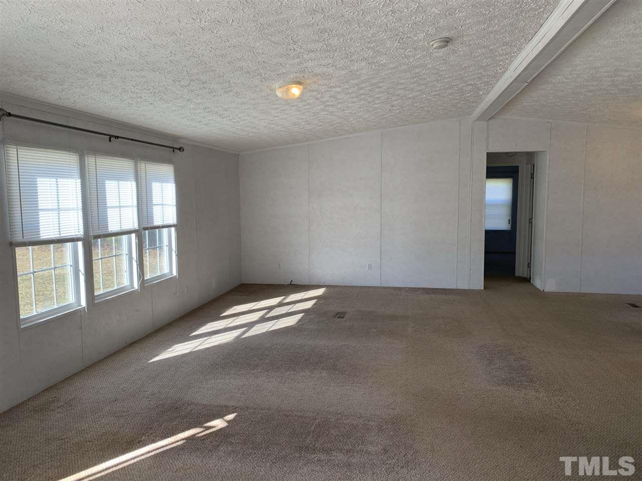 43 Williams Road Spring Hope, NC 27882 - Photo 9 of 30 an empty room with a empty space and windows