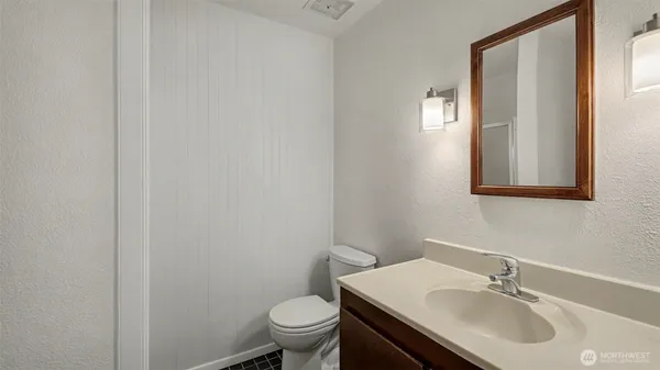 a bathroom with a sink toilet and vanity