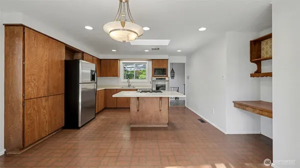 a kitchen with stainless steel appliances granite countertop a refrigerator and a sink