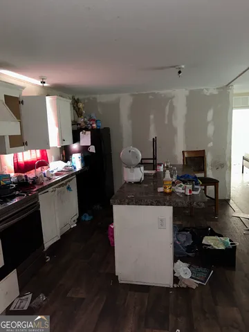 a kitchen that has a sink and a stove in it