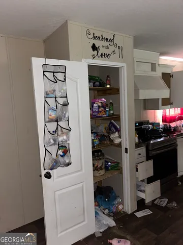 a kitchen with a refrigerator and a stove