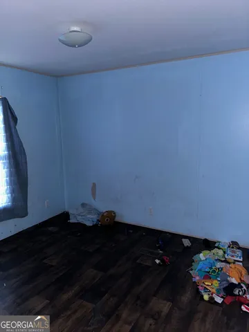 a view of an empty room and wooden floor