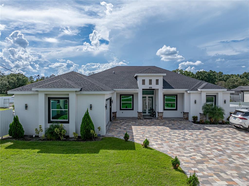 a front view of house with yard and green space