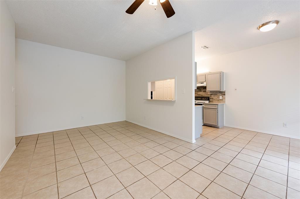 an empty room with white walls and white appliances