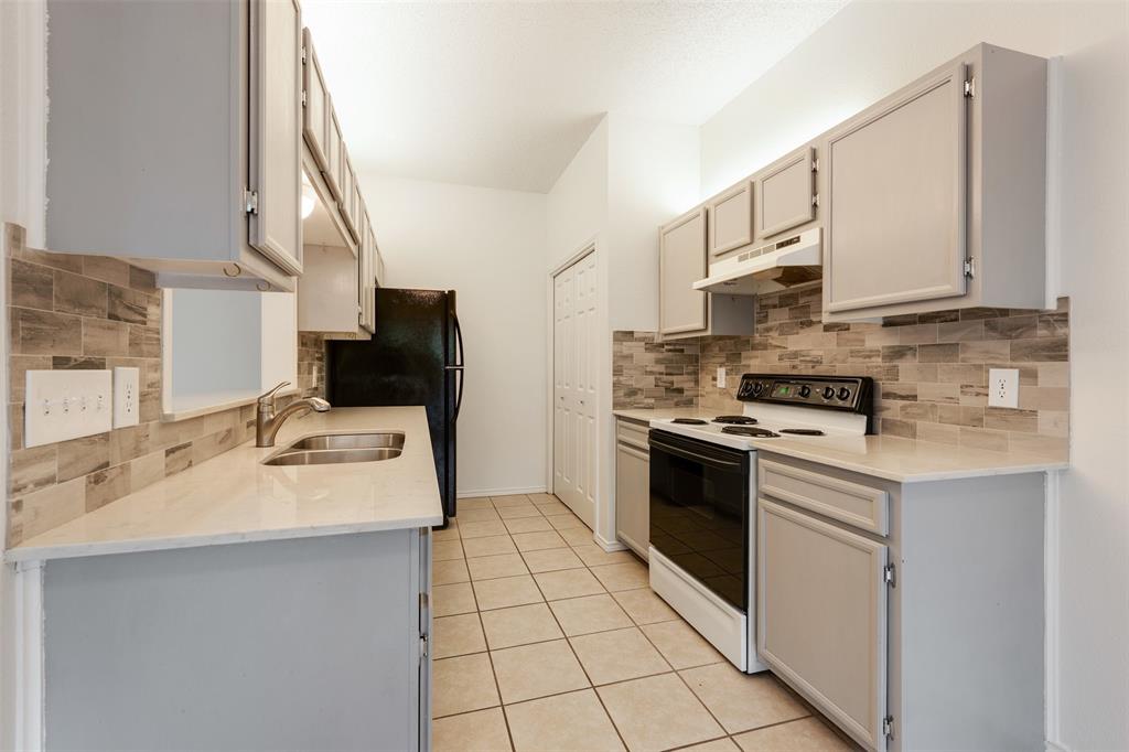 9100 Mountain Ridge Drive, Unit 105 Austin, TX 78759 - Photo 6 of 17 a kitchen with a sink appliances and cabinets