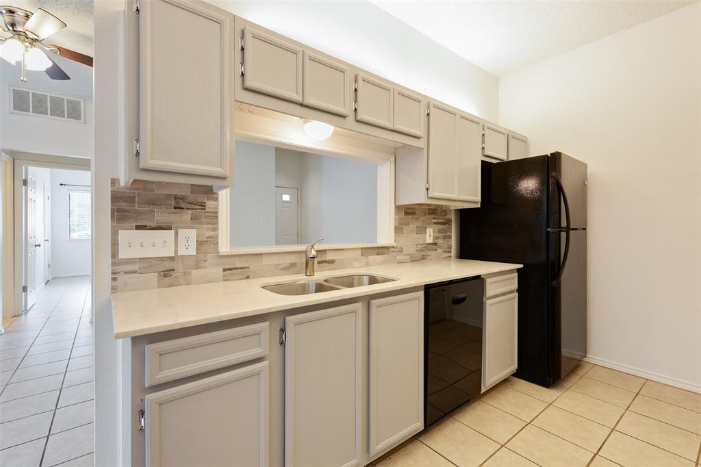 9100 Mountain Ridge Drive, Unit 105 Austin, TX 78759 - Photo 9 of 17 a kitchen with a sink and cabinets