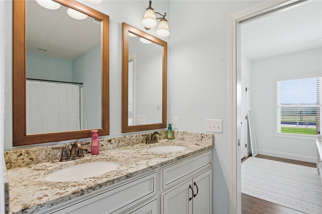 426 Oak Creek Road Seneca, SC 29678 - Photo 24 of 50 Dual vanity with elegant granite counters and warm lighting elevate this functional space.