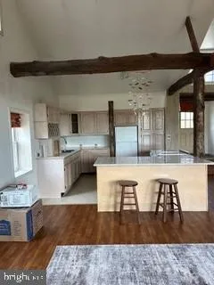 a living room with stainless steel appliances kitchen island granite countertop a sink and a stove