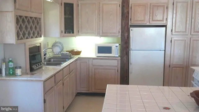 a kitchen with stainless steel appliances a refrigerator sink and cabinets