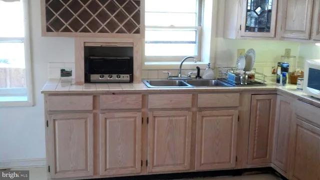 a kitchen with white cabinets and a sink
