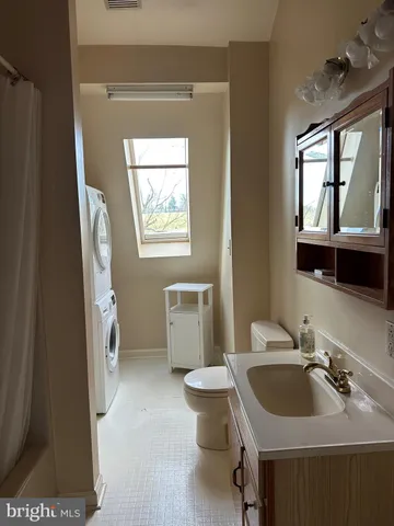 a bathroom with a sink toilet and mirror