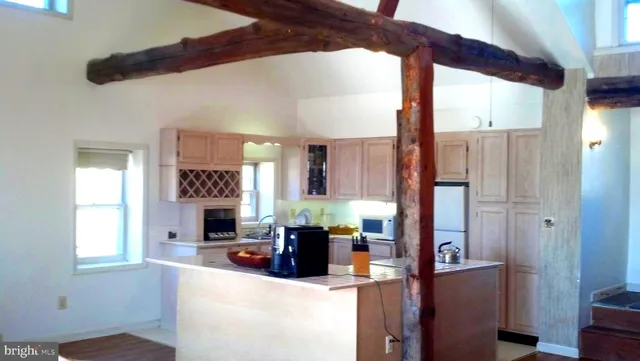 a living room with furniture a large window and flat screen tv