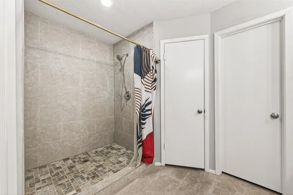 a view of a bathroom with a shower and a sink
