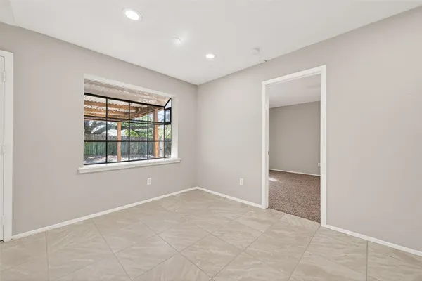 an empty room with windows and closet