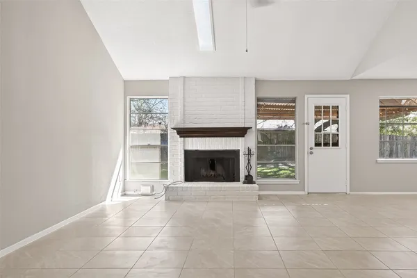 a view of a livingroom with an empty space and a fireplace