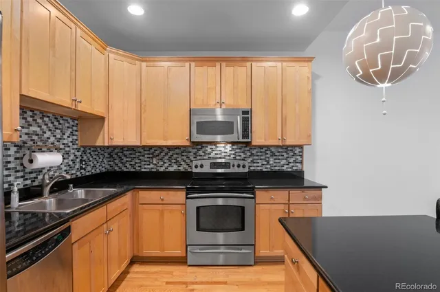 a kitchen with granite countertop a stove and a sink