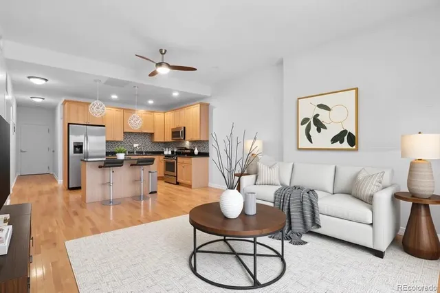 a living room with furniture kitchen view and a table