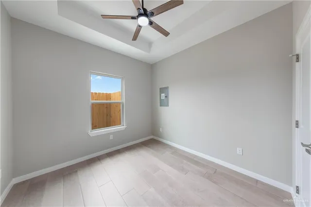 wooden floor in an empty room with a window