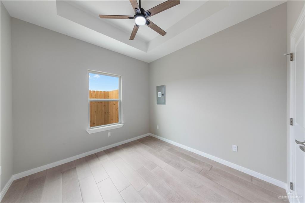 5704 Swallow Avenue, Unit 3 McAllen, TX 78573 - Photo 11 of 21 wooden floor in an empty room with a window