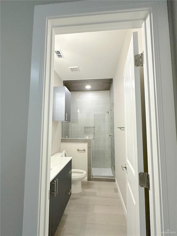 5704 Swallow Avenue, Unit 3 McAllen, TX 78573 - Photo 12 of 21 a spacious bathroom with a glass shower door and a sink