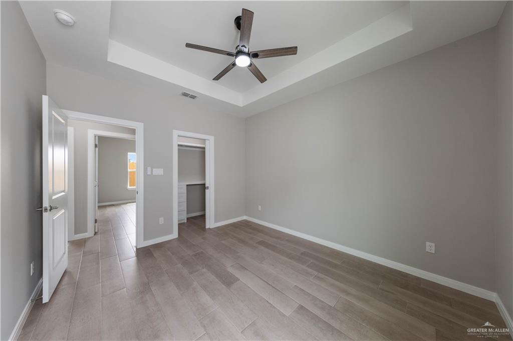 5704 Swallow Avenue, Unit 3 McAllen, TX 78573 - Photo 13 of 21 wooden floor in an empty room with a window