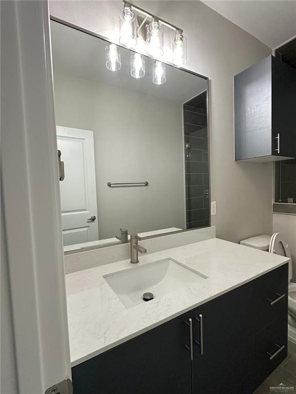 5704 Swallow Avenue, Unit 3 McAllen, TX 78573 - Photo 17 of 21 a bathroom with a sink and a mirror