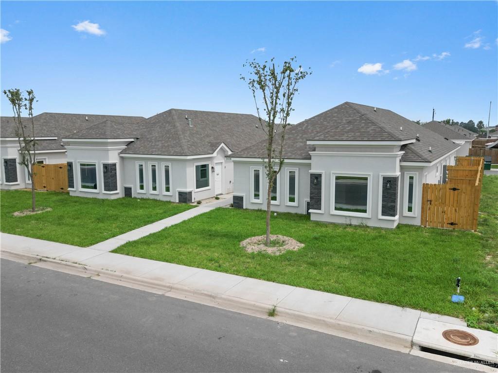 5704 Swallow Avenue, Unit 3 McAllen, TX 78573 - Photo 2 of 21 a front view of a house with a yard and garage