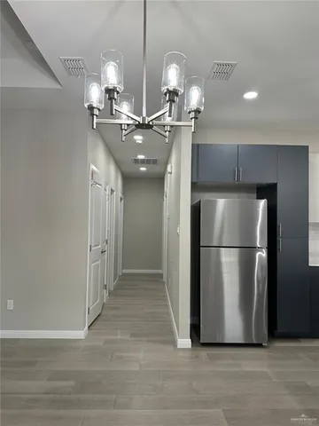 a view of a room with a kitchen