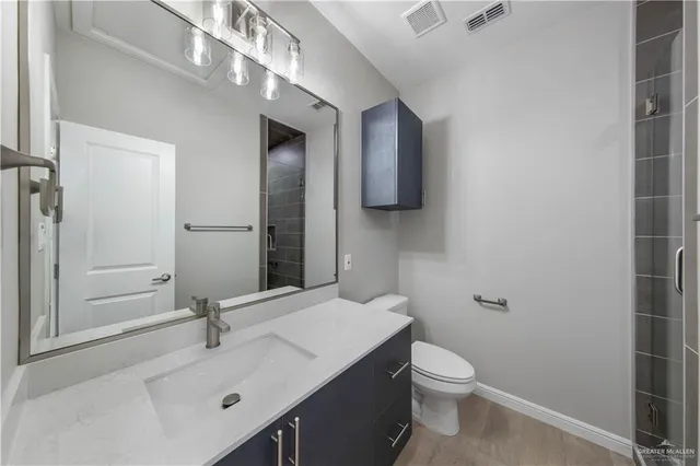a bathroom with a sink toilet and mirror