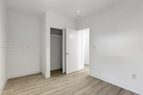 a view of an empty room and wooden floor