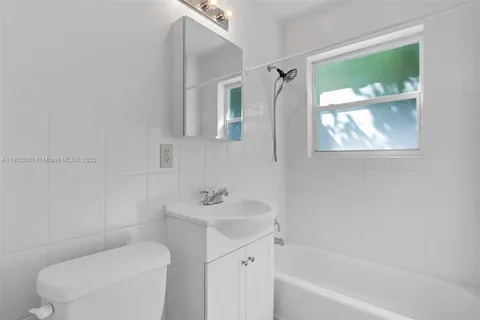 a bathroom with a sink toilet and tub
