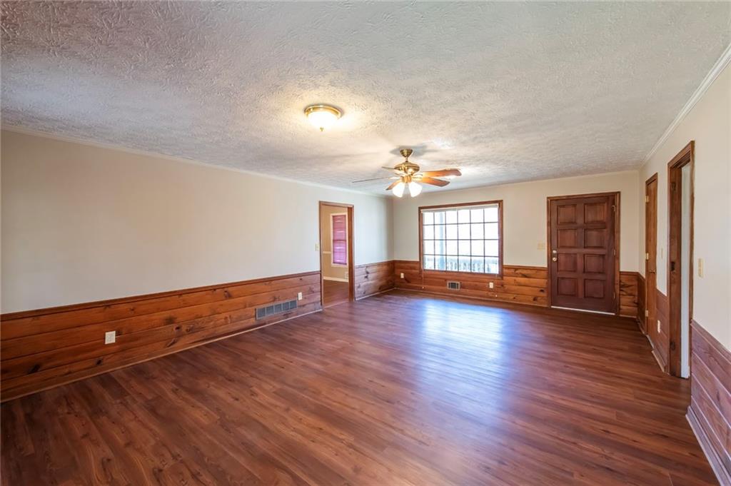 4597 East Glen Ridge Circle Winston, GA 30187 - Photo 13 of 38 an empty room with wooden floor and windows
