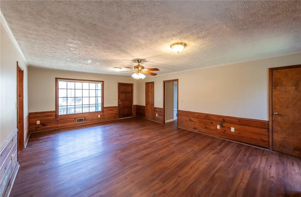 4597 East Glen Ridge Circle Winston, GA 30187 - Photo 14 of 38 an empty room with wooden floor and windows