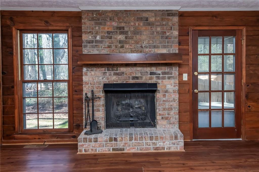 4597 East Glen Ridge Circle Winston, GA 30187 - Photo 15 of 38 a living room with a fireplace and a wooden floor