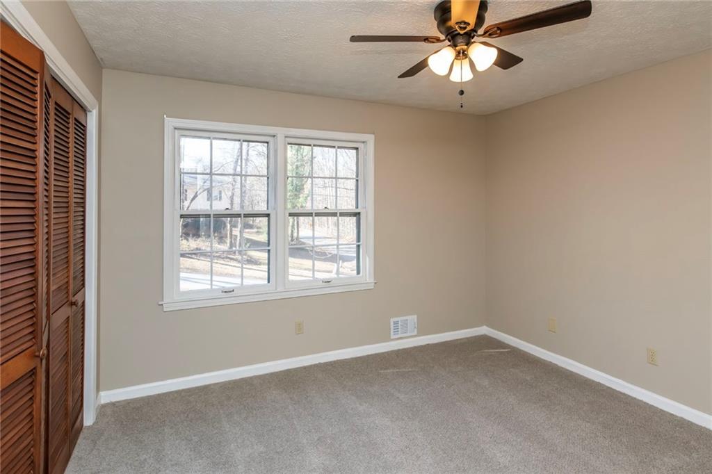 4597 East Glen Ridge Circle Winston, GA 30187 - Photo 23 of 38 an empty room with a window and a fan