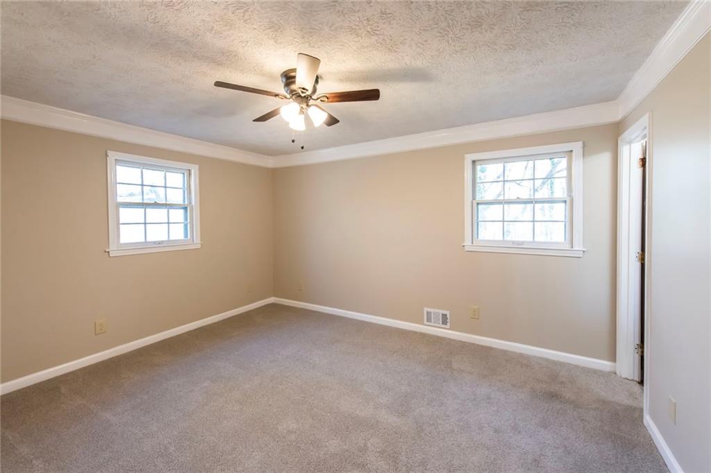 4597 East Glen Ridge Circle Winston, GA 30187 - Photo 26 of 38 an empty room with windows and fan