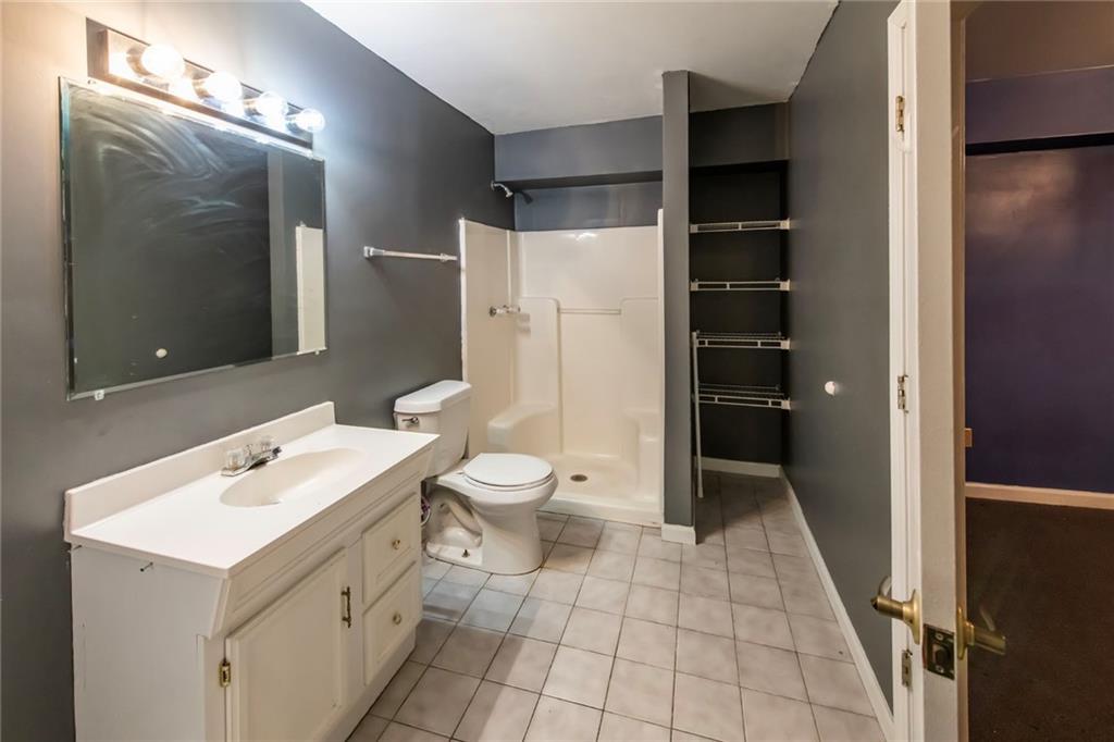 4597 East Glen Ridge Circle Winston, GA 30187 - Photo 32 of 38 a bathroom with a sink a toilet and shower