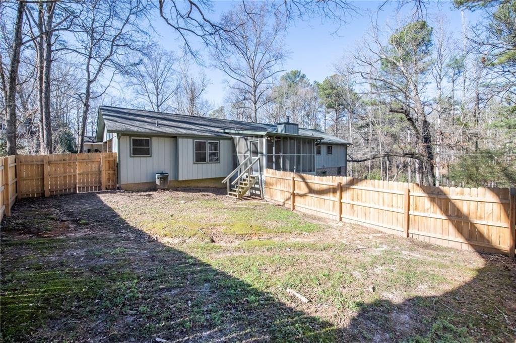 4597 East Glen Ridge Circle Winston, GA 30187 - Photo 7 of 38 a view of a house with backyard and a tree