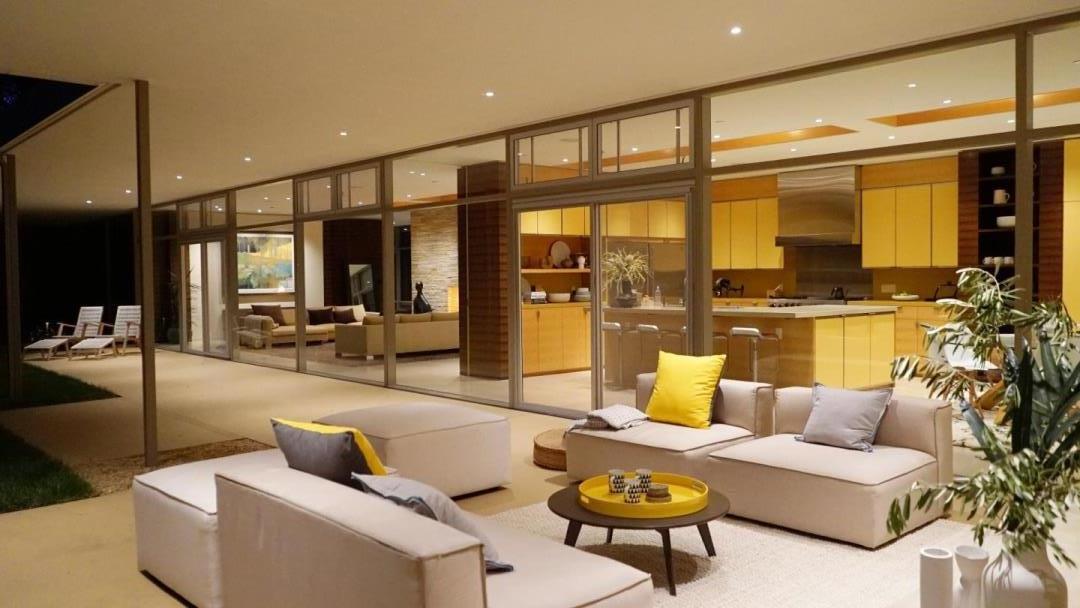 12950 Robleda Road Los Altos Hills, CA 94022 - Photo 1 of 39 a living room with furniture and a large window