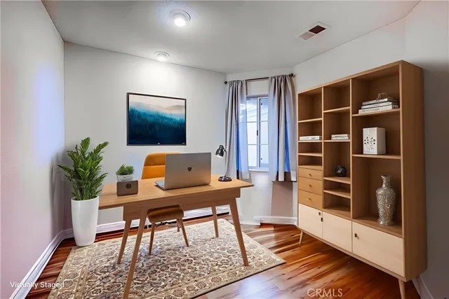 a workspace with furniture window and wooden floor