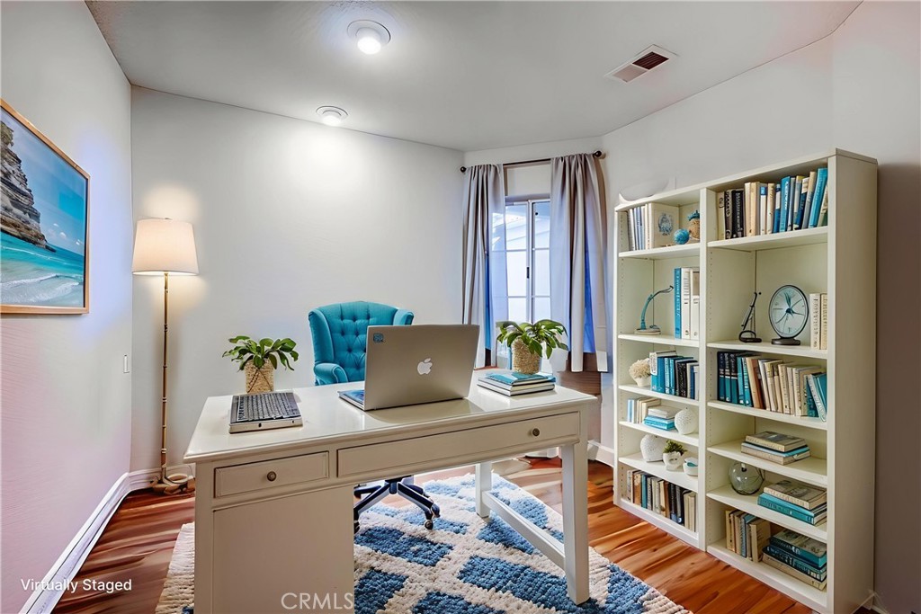 930 Countryside Street Hemet, CA 92545 - Photo 14 of 45 a view of a workspace with furniture and a book shelf