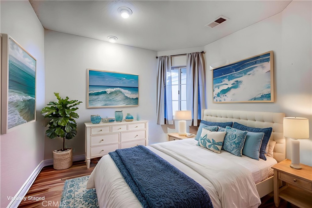 930 Countryside Street Hemet, CA 92545 - Photo 16 of 45 a spacious bedroom with a bed and a potted plant