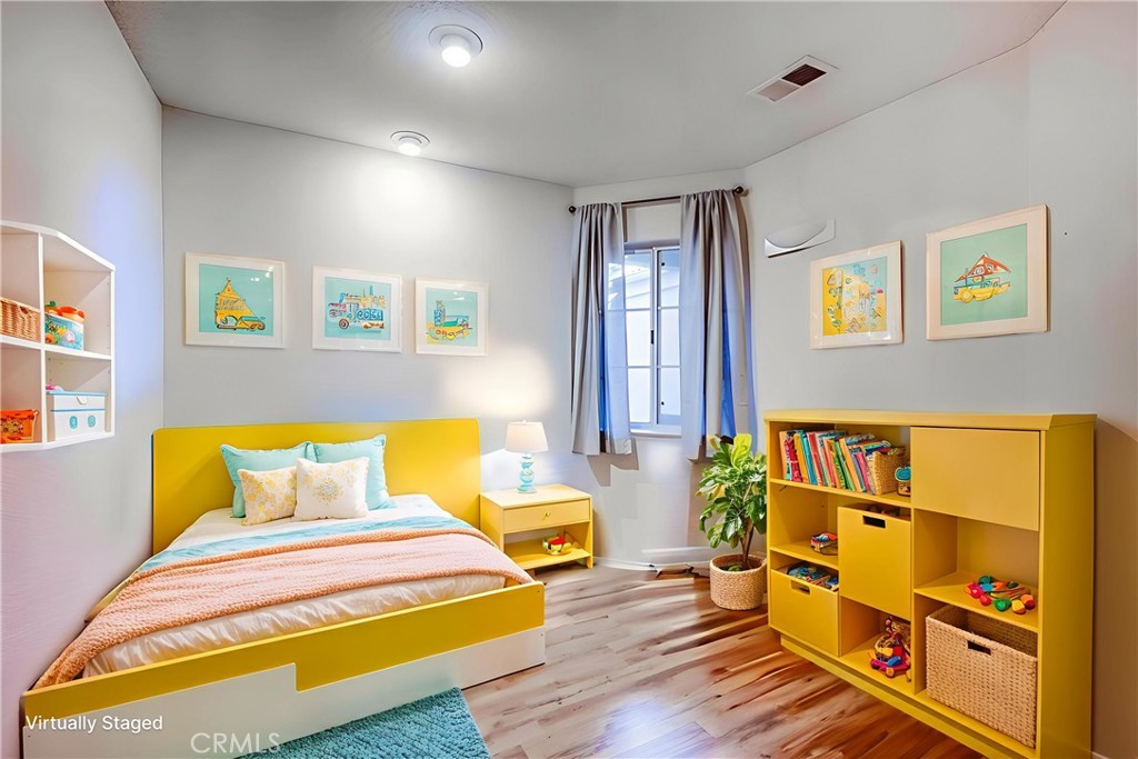 930 Countryside Street Hemet, CA 92545 - Photo 17 of 45 a bedroom with a bed and wooden floor