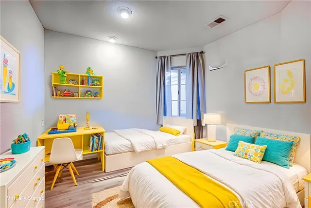 a bed room with two beds and a couch