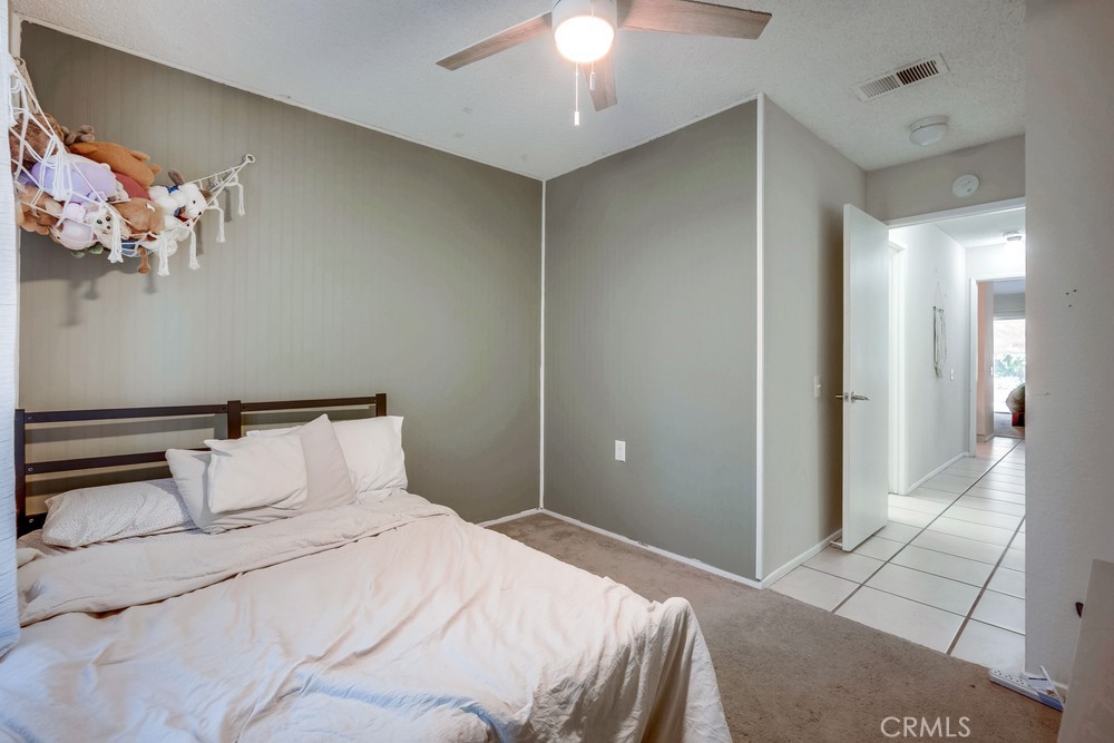 930 Countryside Street Hemet, CA 92545 - Photo 21 of 45 a bedroom with a bed and a chandelier