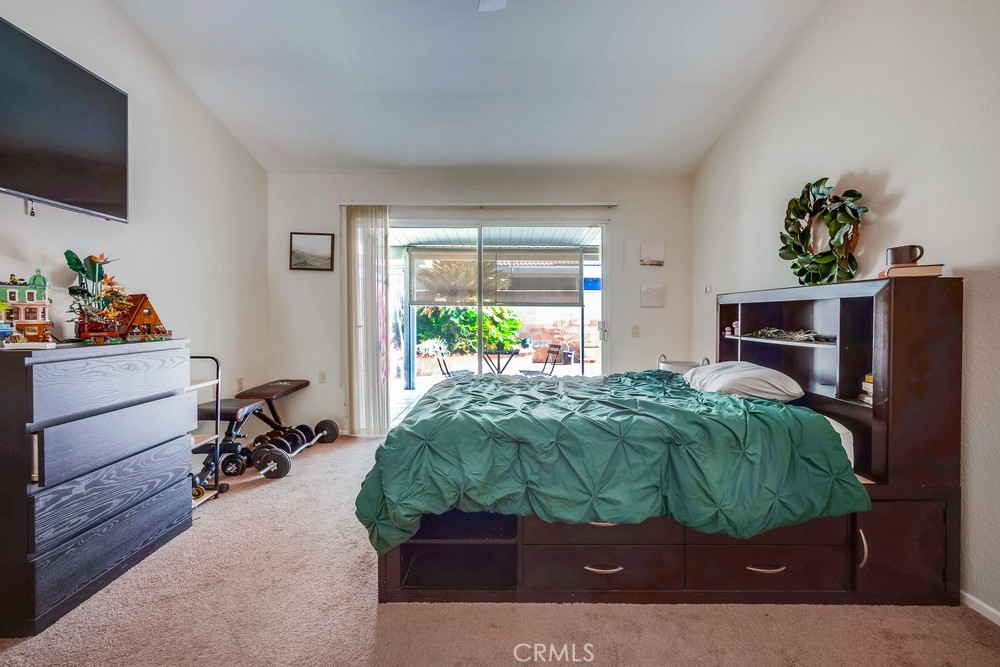 930 Countryside Street Hemet, CA 92545 - Photo 24 of 45 a bedroom with a bed table and a flat screen tv